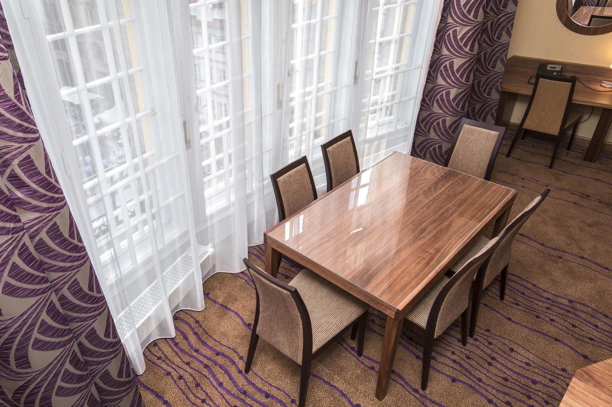 Merchants Crown Suites And Spa Prague Exterior photo A table and chairs